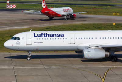 Side view of airplane on airport runway