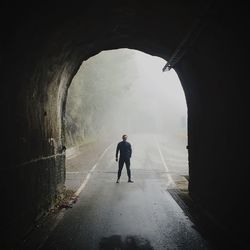 Full length of man standing in tunnel