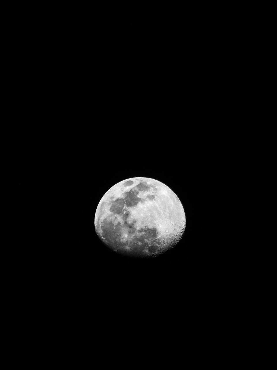 LOW ANGLE VIEW OF MOON AGAINST BLACK SKY