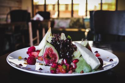 Close-up of fruits in plate on table