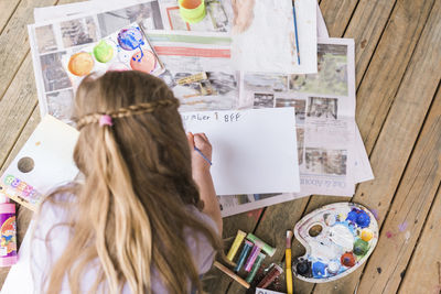 High angle view of girl holding table