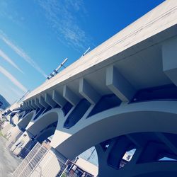 Low angle view of modern building against blue sky