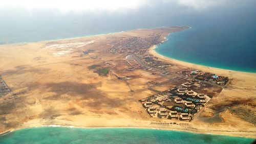 Aerial view of sea and mountains against sky