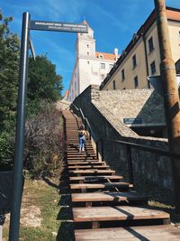 Low angle view of steps amidst buildings against sky