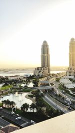 High angle view of city buildings against clear sky