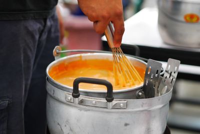 Close-up of person preparing food at kitchen