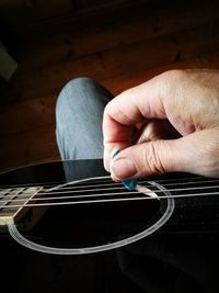 Close-up of person playing guitar