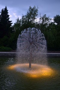 Water splashing in park against sky