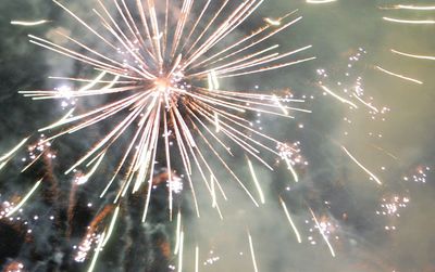 Low angle view of firework display at night