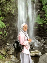 Portrait of smiling young woman in forest