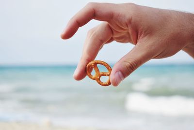 Close-up of hand holding pretzel