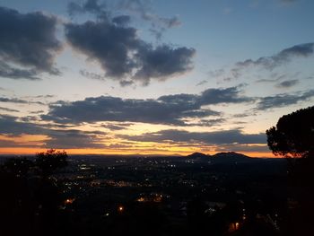 Silhouette cityscape against sky during sunset