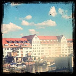 Buildings against cloudy sky