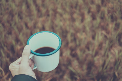 Person holding coffee cup