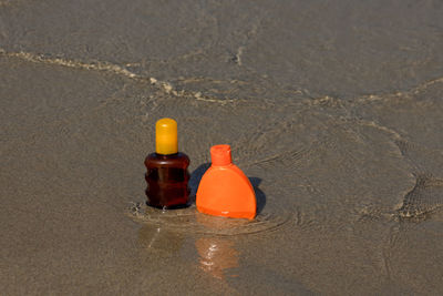 High angle view of bottle on sand