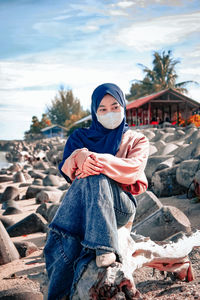 Portrait of young woman on rock