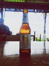 Close-up of beer bottles on table