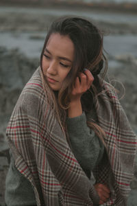 Portrait of young woman standing outdoors