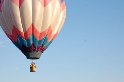 Low angle view of hot air balloons against clear sky