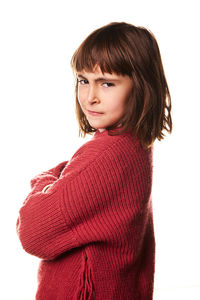 Portrait of young woman standing against white background