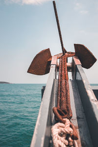 Traditional windmill on shore against sky