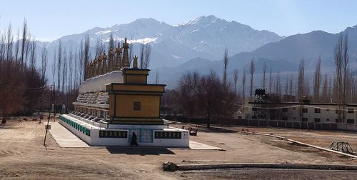 Built structure on snowcapped mountain against sky