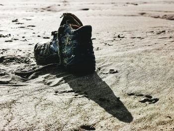High angle view of shoes on sand at beach
