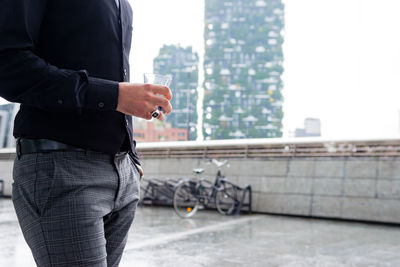 Man with umbrella standing in city