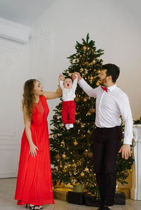 New year and christmas. mom and dad hold hands with their little son in the background 