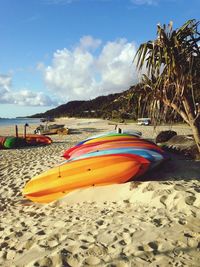 Boats moored on beach against sky