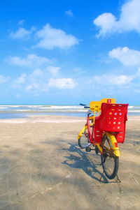 Bicycle on beach against sky