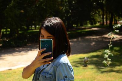 Woman holding phone towards camera