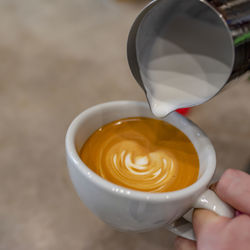 Close-up of hand holding coffee cup