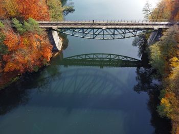 Bridge over river against sky during autumn