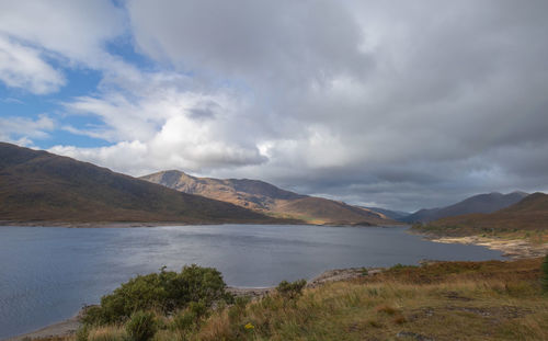 Scenic view of lake and mountains against sky