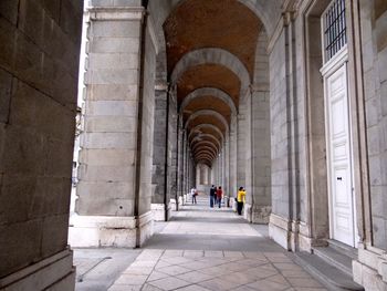 People in corridor of historic building