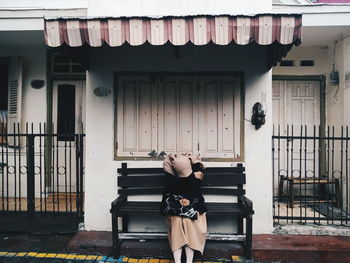 Full length of women standing outside house