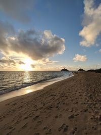 Scenic view of beach against sky during sunset