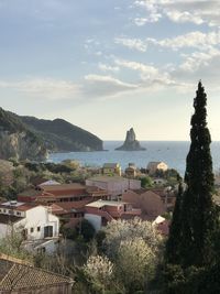 High angle view of village by sea against sky in corfu island greece 