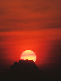 Silhouette tree against orange sky