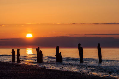 Scenic view of sea against orange sky