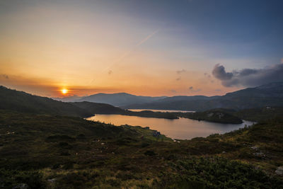 Scenic view of lake against sky during sunset