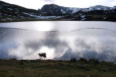 Scenic view of lake and mountains against sky