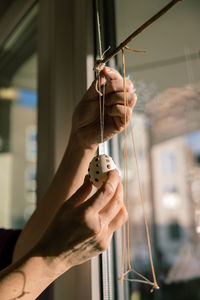 Cropped hand of man holding metal