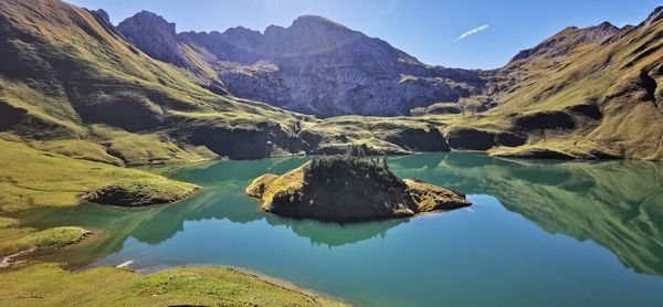 Scenic view of lake and mountains against sky