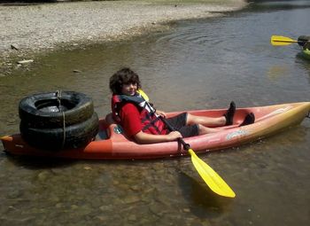 Rear view of a woman sitting in boat