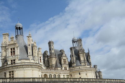 Low angle view of historic building against cloudy sky