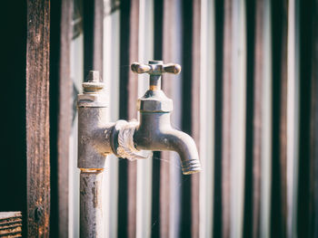 Close-up of faucet against wall