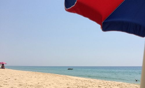 Scenic view of beach against clear sky