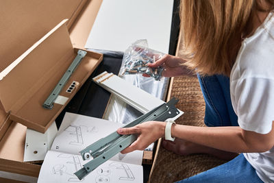 Midsection of woman working on table